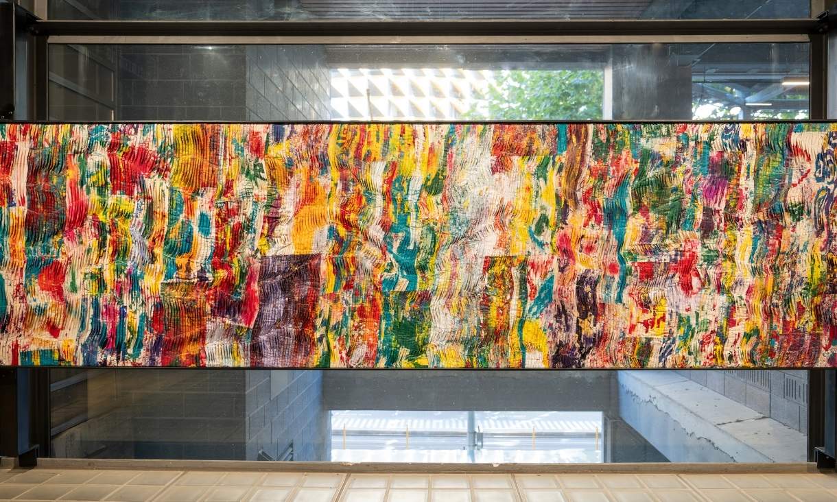 Long artwork covered in colourful paint